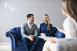 © BestForYou - Happy young couple making up at therapy session with psychologist.