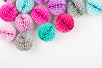 Wall Mural - Honeycomb balls decorations background. Pink, lilac and turquoise paper pom pom. Flat lay. Holiday concept