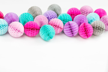 Wall Mural - Honeycomb balls decorations background. Pink, lilac and turquoise paper pom pom. Flat lay. Holiday concept