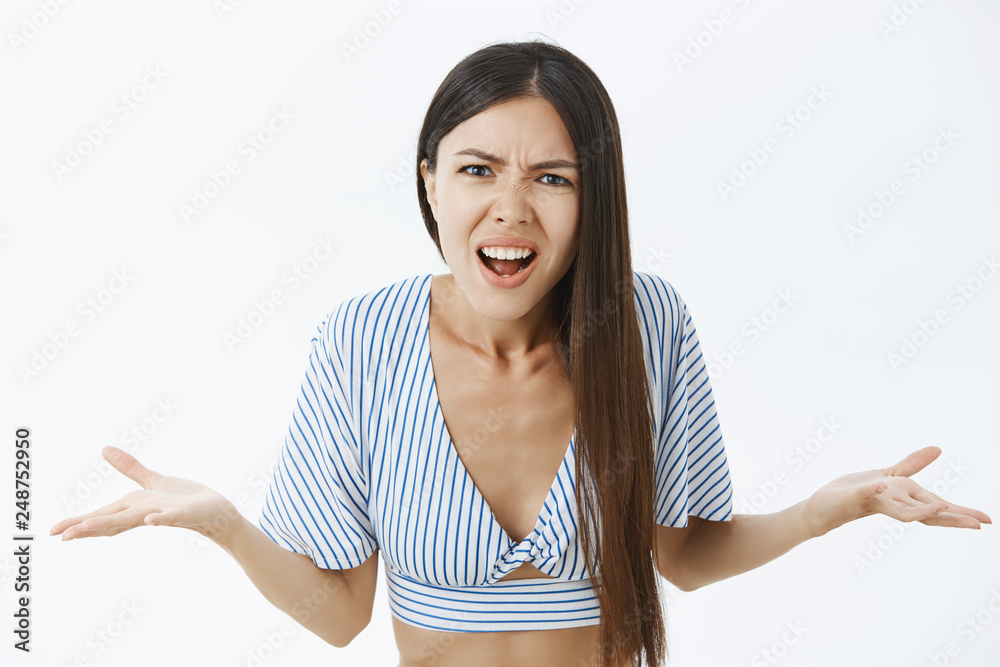 Waist-up shot of pissed and angry confused asian female shrugging with ...