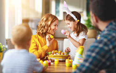 Wall Mural - Happy easter! family mother, father and children paint eggs for   holiday