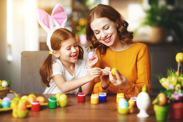 Wall Mural - Happy easter! family mother and child daughter with ears hare getting ready for holiday.