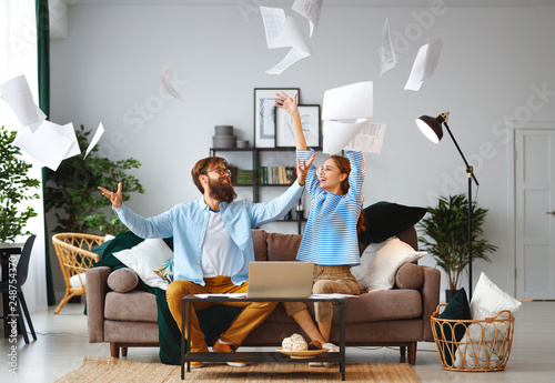 Fotomural married couple with bills receipts documents and laptop at home.