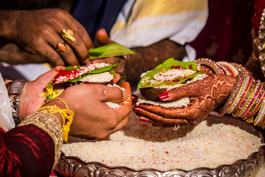 Bride and Groom Offer Rice as a Symbol of Plenty at a South Indian Wedding Ceremony Wedding in Hyderabad, India