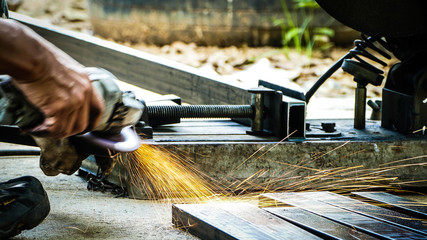 Worker cutting steel