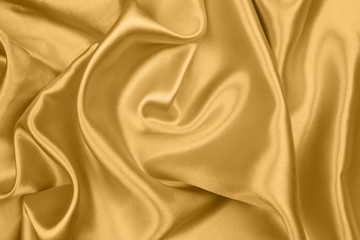 Smooth elegant gold silk or satin texture can use as abstract background