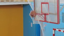 Basketball Ball Flies Into The Basket In The Old Sports Hall. Slow Motion.