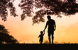 © kieferpix - father and son holding hands walking in the park
