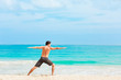 © kieferpix - young man doing yoga on the beach