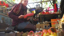 Girl Looking The Typical Dutch Clogs At A Souvenir Market On A Beautiful Sunny Day. Amsterdam Netherlands. Flat Plane
