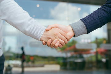 Portrait of successful mid adult partners shaking hands