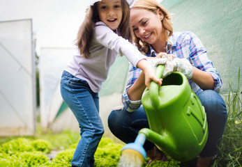 Mother and daughter working in the farm.