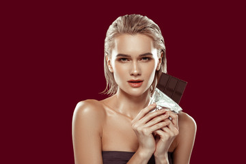 Wall Mural - Model wearing open shoulders top having chocolate in hands