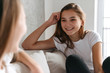 © Drobot Dean - Two cheerful girls talking while sitting at home