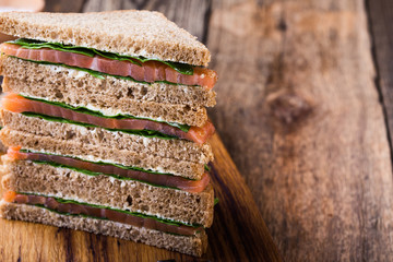 Wall Mural - Healthy vegetarian sandwiches with smoked salmon and greens