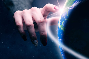 Poster - Woman touching planet with finger. Nebula dust in infinite space. Mixed media.
