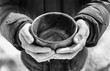 Men hand holding empty wooden bowl. Black and white.