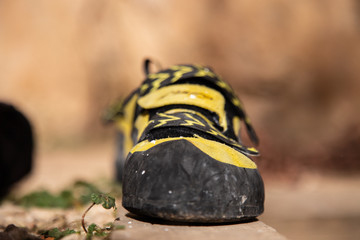 Closeup of cat foot boot in black and yellow colors for climbing in mountains