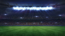 Grand Football Stadium Middle View Illuminated By Spotlights And Empty Green Grass