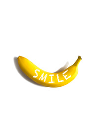 Wall Mural - Ripe banana with word Smile on white background, flatlay, copy space