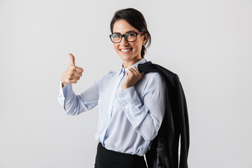 Sticker - Image of happy secretary woman wearing eyeglasses holding jacket while standing in the office, isolated over white background