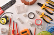 Tools and electrical material on a white table top general