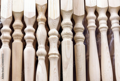 Fotomural Wooden balusters of pine for the staircase railing.