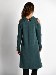 Wall Mural - Young beautiful woman posing in new design casual green winter dress back view on grey  