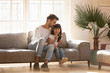 © fizkes - Happy dad embracing kid daughter enjoy using smartphone at home