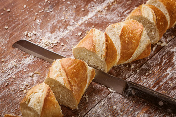 Poster - sliced bread on a wooden table. fresh baking concept