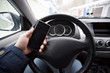 © Александр Поташев - Man talking on the phone while driving a car