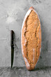 © Jultud - rustic bread loaves and old knife resting on gray marbled background