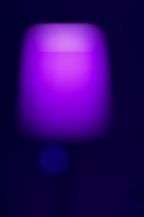 Poster - purple glowing abstract forces on a dark background, colored lights blurred