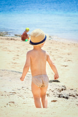 Happy child playing on the sea background