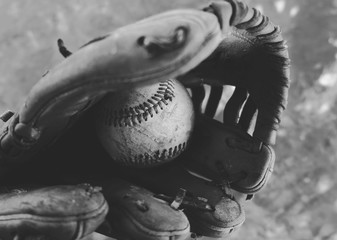 Wall Mural - Baseball in glove closeup shows used sport equipment in black and white.