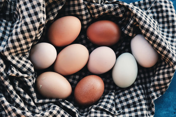 Brown chicken eggs on rustic plaid cloth for country style food.