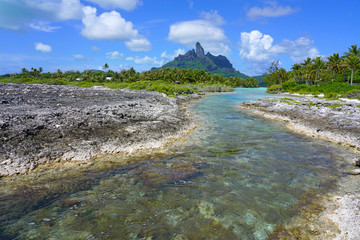 Wall Mural - View of the Mont Otemanu mountain seen from the water over the reef between the ocean and the lagoon in Bora Bora, French Polynesia, South Pacific