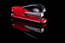 red stapler on black background