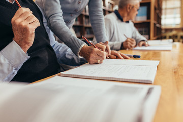 Close up of senior people sitting in class and learning