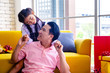 © Teerayut - Young Asia dad and daughter in living room at house.They are happy and cheerful.Happy family,together. Photo enjoy and  happy family concept idea.