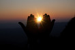 Faith of christian concept: Spiritual prayer hands over sun shine with blurred beautiful sunset background