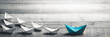 Blue Paper Boat Leading A Fleet Of Small White Boats On Wooden Table With Vintage Effect - Leadership Concept
