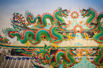 Colorful chinese dragon statues on roof in Chinese temple. Chinese dragons on the roof top of shrine.