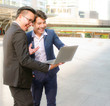 © studio2013 - Great job ,two young asian business man keeping arms raise celebrating success in working teamwork concept with laptop