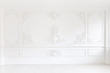 © stock28studio - Beautiful ornate white decorative plaster mouldings in studio. The white wall is decorated with exquisite elements of plaster stucco