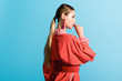 © LIGHTFIELD STUDIOS - beautiful stylish girl posing in trendy living coral clothing isolated on blue