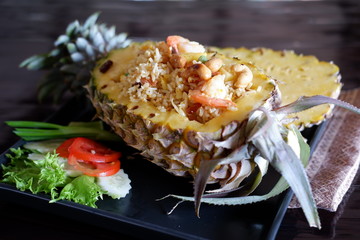 Canvas Print - Fried rice with pineapple on wooden table