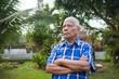 © meeboonstudio - Portrait of elderly man standing in his garden.
