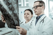 © Viacheslav Yakobchuk - Couple of professional doctors attentively reviewing x-ray photo