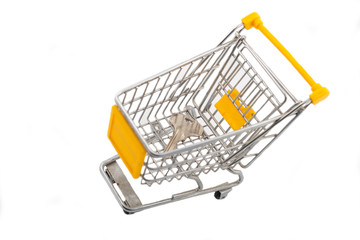 small trolley from a supermarket with an apartment or house key on a white background